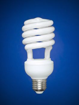 Compact fluorescent light bulb isolated over blue background.