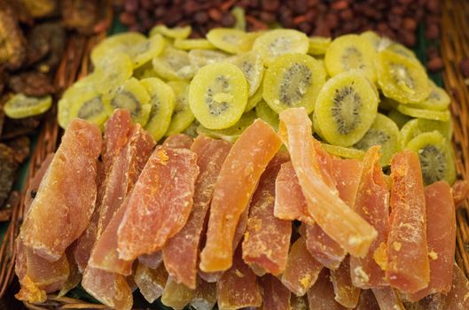 Crystallized fruit in wicker basket on the market. Shallow focus.