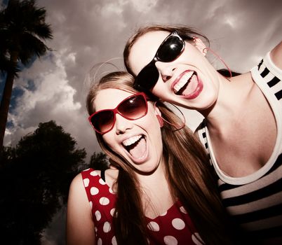 Fashion Girls on a Stormy Day Against Cloudy Sky