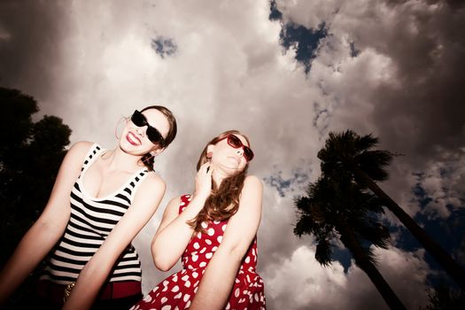 Fashion Girls on a Stormy Day Against Cloudy Sky