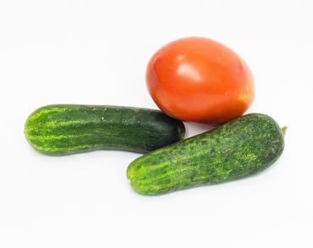 red tomato and cucumber together on a white background 