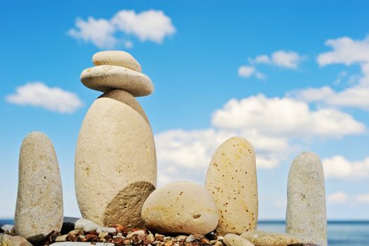 Cobble-stones grouped on the shore of ocean on the background cloud