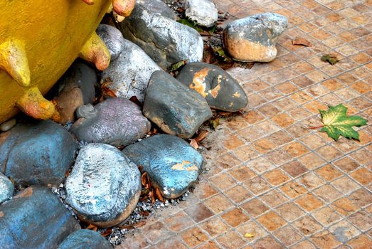 Composition with colored stones, strange artifact and autumn leave