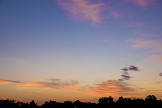 Orange clouds over the horizon at sunrise