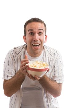 A young man holding a bowl of popcorn and watching a movie, isolated against a white background