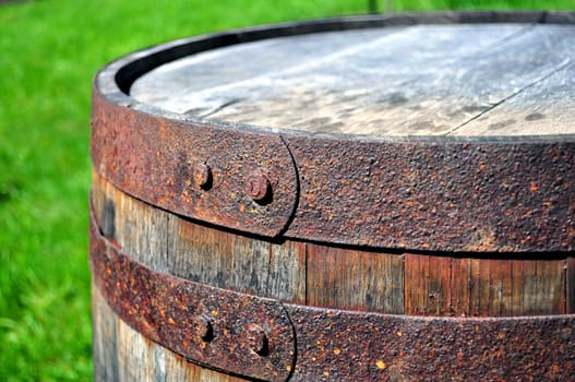 Detail of rusty metal on wood barrel