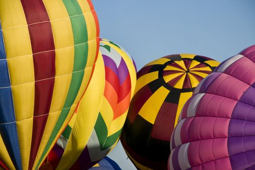 Several hot-air balloons being inflated