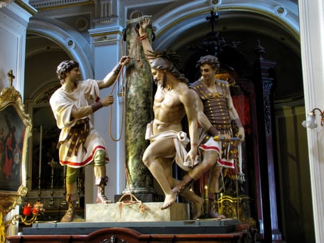 A group of statues portraying the scourging of Jesus Christ in Qormi, Malta.