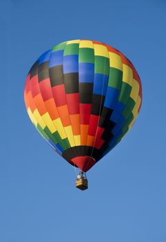Colorful hot-air balloon floating against blue sky