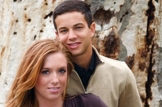 Young couple in an autumn forest picnic area