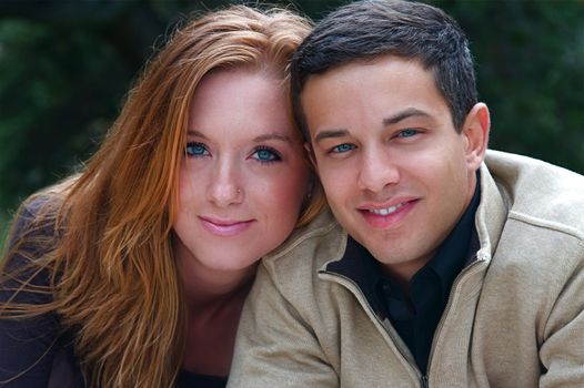 Young couple in an autumn forest picnic area