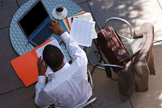 Young Businessman works on a computer outdoors