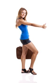 Beautiful young woman hitch hiking with old leather suitcase, isolated on white