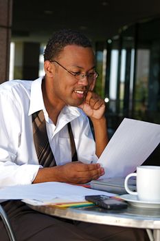 Young Businessman works on a computer outdoors