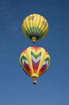 Hot-air balloon flying directly above another 