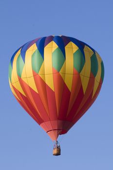 Colorful hot-air balloon floating against blue sky