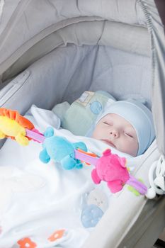 Sweet baby boy sleeping in carriage