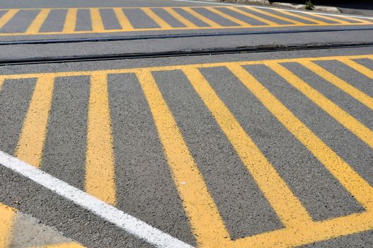Yellow strips painted on street at railroad crossing