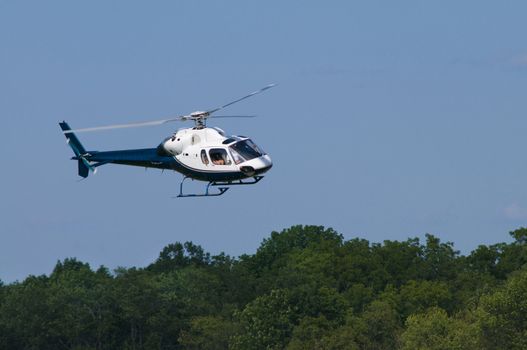 Helipcopter landing or taking off over trees