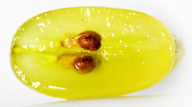 Translucent slice of green grape fruit, macro isolated on white 