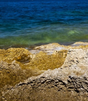 Detail of a rocky reef in Malta with beautiful crystal clear ocean water