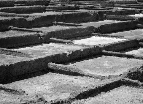 Ancient saltpanes from Roman times carved in sandstone in Malta