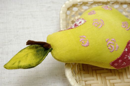Soft toy "Pear" in the basket. Made of fabrics. It's used for kitchen decoration.