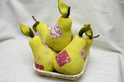 Plush Pears in the basket. Made of fabrics. It's used for kitchen decoration.