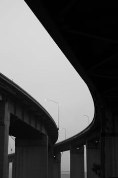 Close up of the empty freeway ramps in a fog.