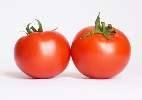 Two tomatoes isolated on white background 