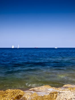 Detail of a rocky reef in Malta with beautiful crystal clear ocean water