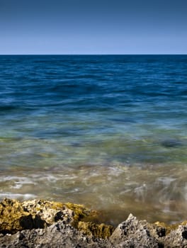 Detail of a rocky reef in Malta with beautiful crystal clear ocean water