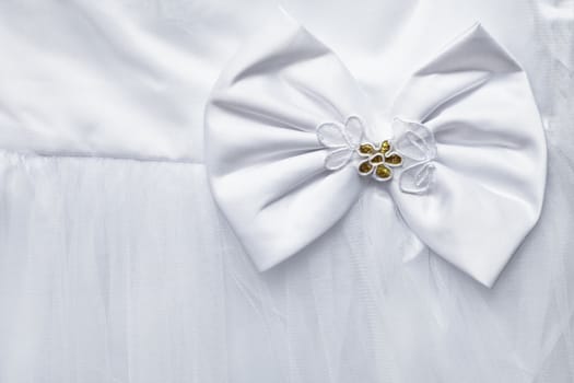 Big bow decorating the white dress - background