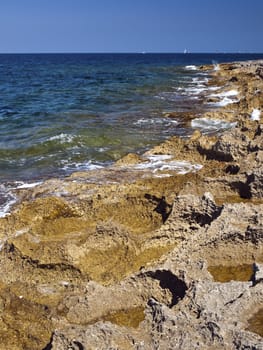 Detail of a rocky reef in Malta with beautiful crystal clear ocean water