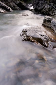 It is a beautiful river flow over the stone.