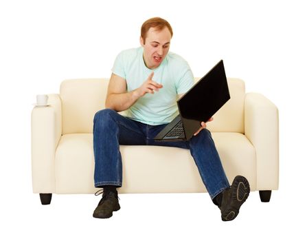 The man was talking with a computer sitting on the couch