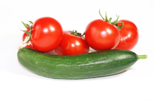 Fresh cucumber and tomatoes on white background