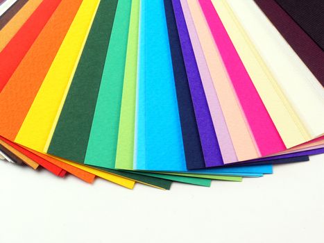 Colored samples of different papers on white background, business cards