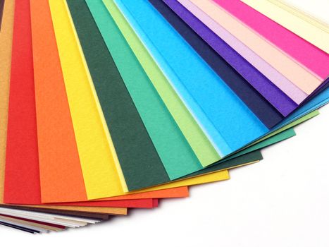 Colored samples of different papers on white background, business cards