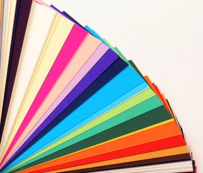 Colored samples of different papers on white background, business cards