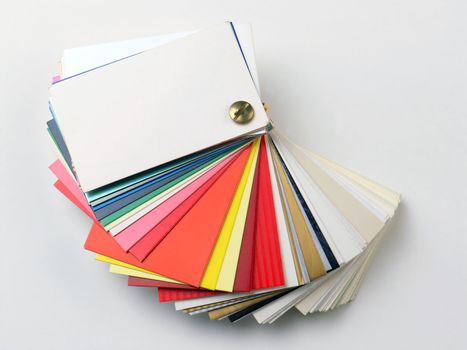 Colored samples of different papers on white background, business cards