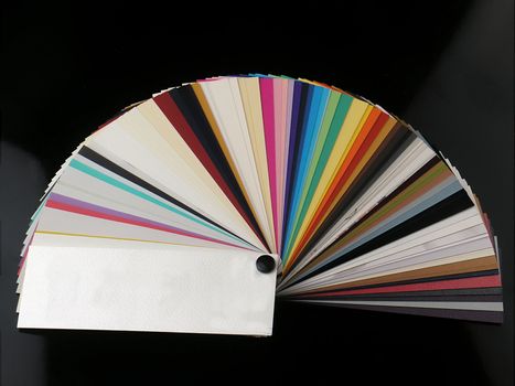 Colored samples of different papers on white background, business cards