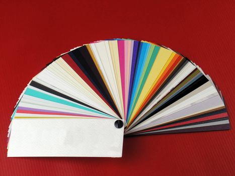 Colored samples of different papers on white background, business cards