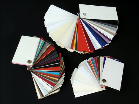 Colored samples of different papers on black background