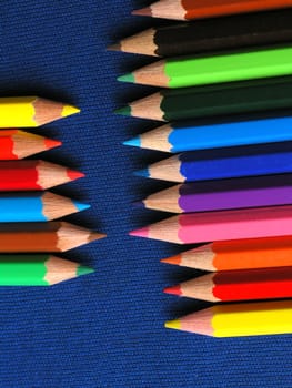 Colored Pencils in a Row on blue background