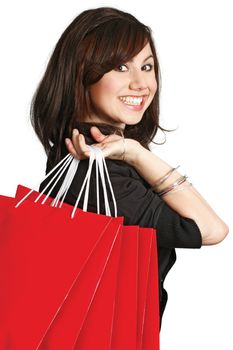 A very happy shopping girl holding bags and smiling wildly about her rabid consumerism.
