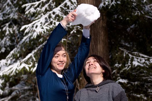 Two ladies in medieval dresses in winter forest
