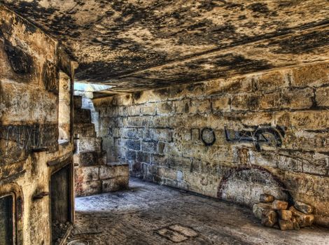 Derelict wartime British bunker and gun post lying in ruins
