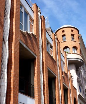 Eccentric facade of an orange building with blue sky