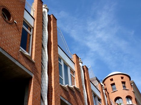 Eccentric facade of an orange building with blue sky